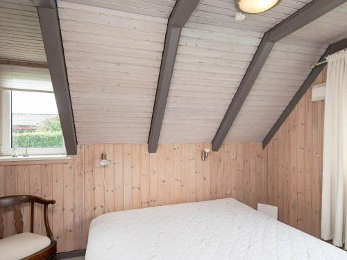 a bedroom with a white bed and a window at 6 person holiday home in Hejls in Hejls