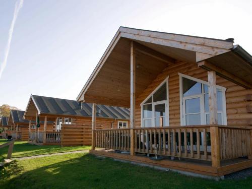 a log cabin with a porch and a large window at 6 person holiday home in Allinge in Allinge