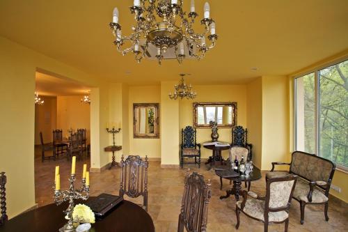 a dining room with a dining table and a chandelier at U Marii Hotel in Gorzów Wielkopolski