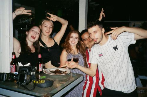 a group of people posing for a picture at a party at The Desire Hostel in New Delhi