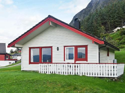 ein kleines weißes Haus mit rotem Dach in der Unterkunft 7 person holiday home in Selje in Selje