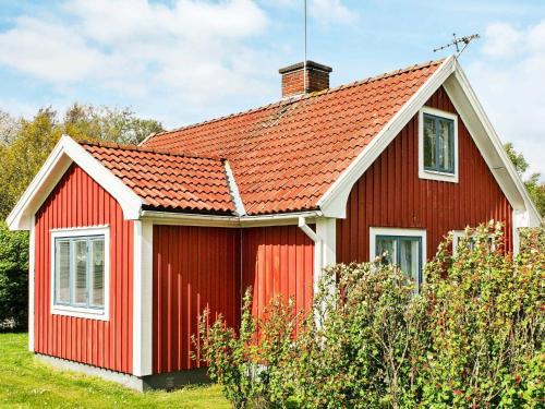 una casa roja con techo naranja en 4 person holiday home in S DER KRA, en Söderåkra