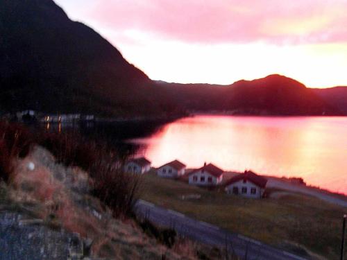 a view of a lake with houses next to a mountain at 5 person holiday home in Selje-By Traum in Selje