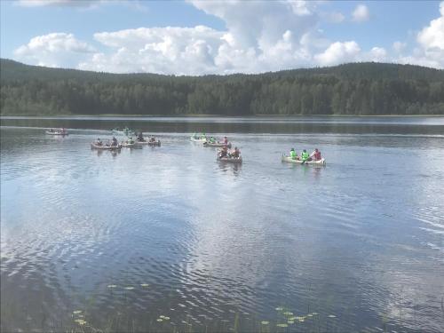 a group of people in boats on a lake at Ängsliden in Charlottenberg