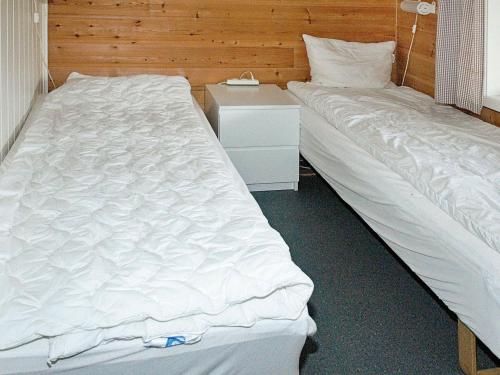 two beds sitting next to each other in a bedroom at 8 person holiday home in Sørbøvåg in Sørbø