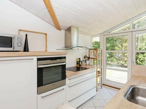 a kitchen with a sink and a stove top oven at Nature Retreat in albaek - By Traum Ferienwohnungen in Jerup