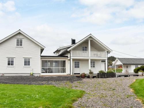 a white house with a yard at 10 person holiday home in Tornes I Romsdal in Tornes