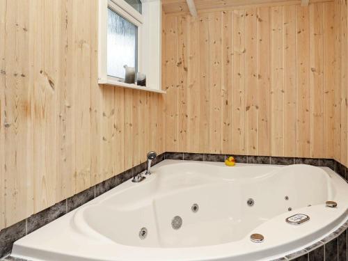 a white bath tub in a room with wooden walls at 7 person holiday home in Thisted in Nørre Vorupør