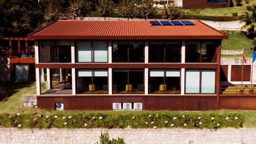 a model of a house with a red roof at Agrinho Suites & Spa Gerês in Valdosende