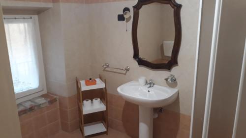 a bathroom with a sink and a mirror on the wall at Agriturismo Cascina Binelli in Dogliani