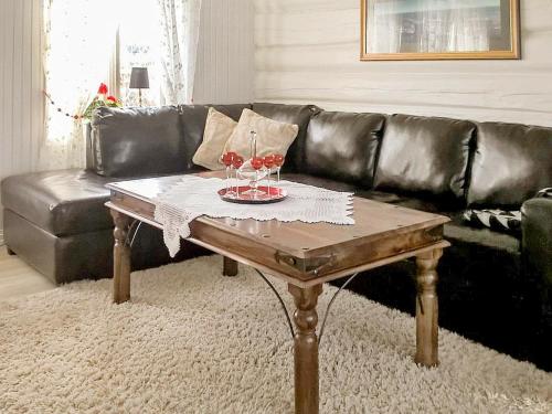 a living room with a table with two glasses of wine at 8 person holiday home in averøy in Henda