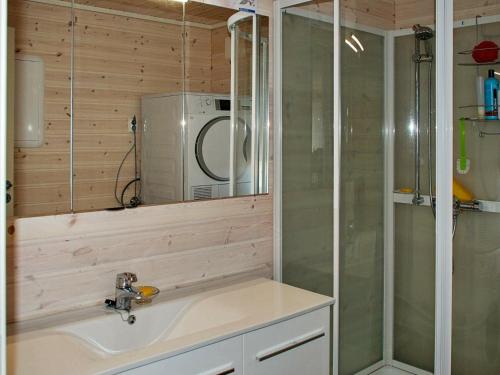 a bathroom with a sink and a microwave at 6 person holiday home in Dønna in DÃ¸nnes