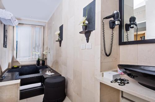 a bathroom with a black sink and a phone at Villa Marina Capri in Capri