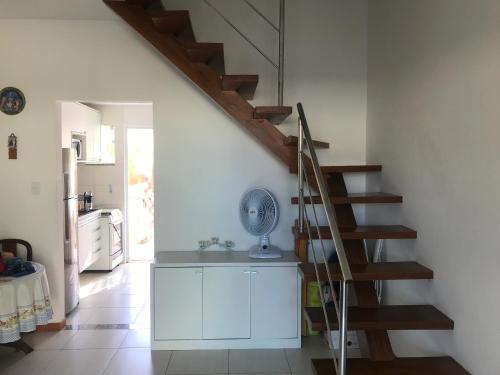a staircase in a room with a kitchen and a kitchen at Imbassai Summer Flats Village in Imbassai