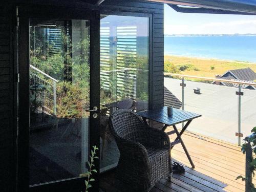 an open door to a balcony with a table and chairs at 2 person holiday home in Slagelse in Slagelse