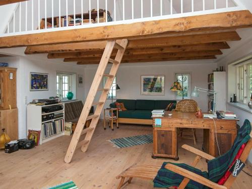 a loft bed in a living room with a desk at 7 person holiday home in Bredebro-By Traum in Ballum