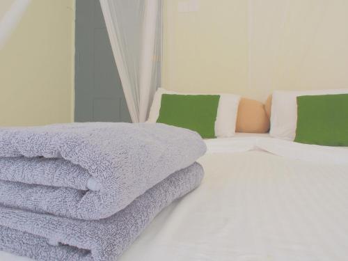 a pile of towels sitting on top of a bed at Secret Garden Galle Fort in Galle
