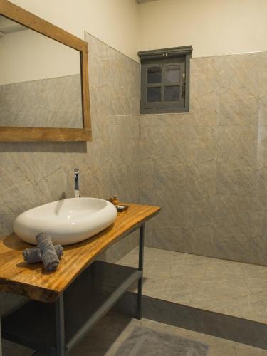 a bathroom with a sink and a mirror at Secret Garden Galle Fort in Galle