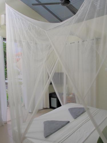 a white bed with a canopy in a room at Secret Garden Galle Fort in Galle