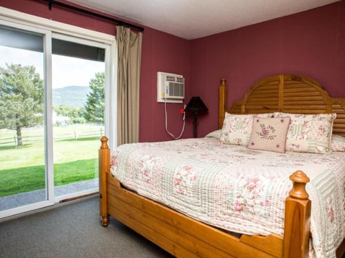 a bedroom with a wooden bed and a window at Manchester View in Manchester
