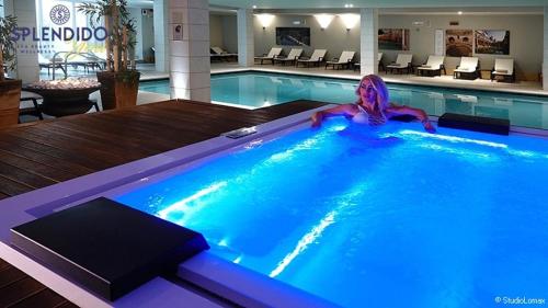 a swimming pool with a mermaid in a hotel at Splendido Bay Luxury Spa Resort in Padenghe sul Garda