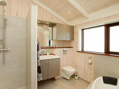 a bathroom with a toilet and a sink and a shower at Holiday Home Kandestedvej in Starholm