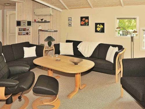 a living room with a couch and a table at 8 person holiday home in Oksb l in Øster Vrøgum