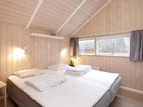 a large white bed in a room with a window at Three-Bedroom Holiday home in Nykøbing Sj 7 in Lumsås