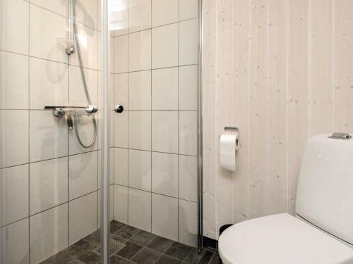 a bathroom with a shower with a toilet and a toilet paper roll at 6 person holiday home in Juelsminde-By Traum in Sønderby