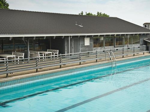 een zwembad voor een gebouw bij 8 person holiday home in Aabenraa in Danland Løjt