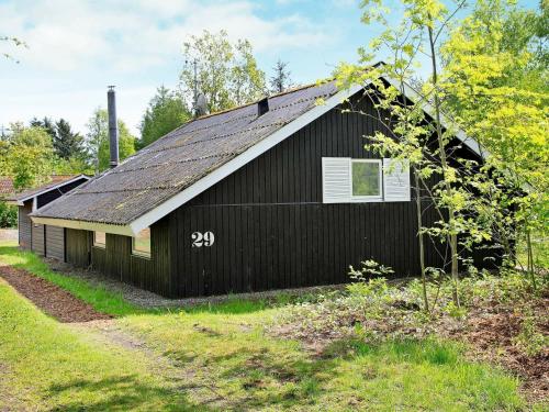 a black barn with the number written on it at 6 person holiday home in Ansager-By Traum in Ansager