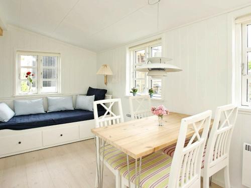 a dining room with a couch and a table at 4 person holiday home in Skagen-By Traum in Skagen