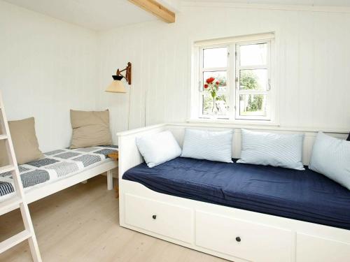 a bedroom with a bed and a window at 4 person holiday home in Skagen-By Traum in Skagen