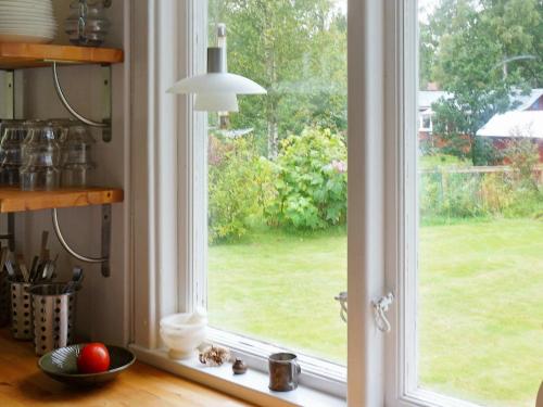 a window in a kitchen with a view of a yard at 4 person holiday home in BORÅS in Borås