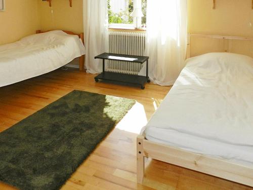 a living room with two beds and a rug at 3 person holiday home in LYSEKIL in Lysekil