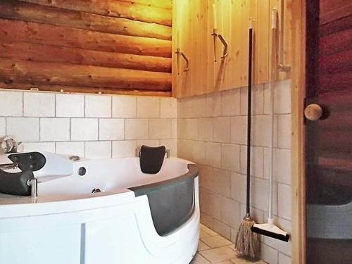 a bathroom with a bath tub and a sink at Three-Bedroom Holiday home in Lemvig 8 in Lemvig