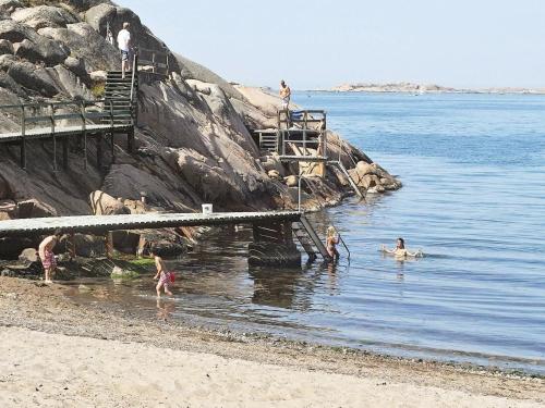 a group of people in the water at the beach at 3 person holiday home in LYSEKIL in Lysekil
