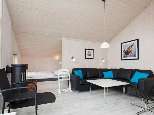 a living room with a couch and a table at 6 person holiday home in Gro enbrode in Großenbrode