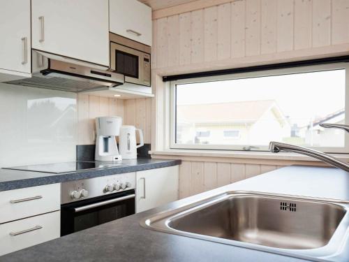 a kitchen with a stainless steel sink and a window at 6 person holiday home in Gro enbrode in Großenbrode