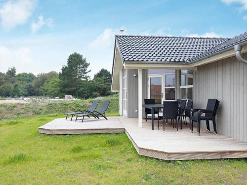 a deck with chairs and a table on a house at 8 person holiday home in Gro enbrode in Großenbrode