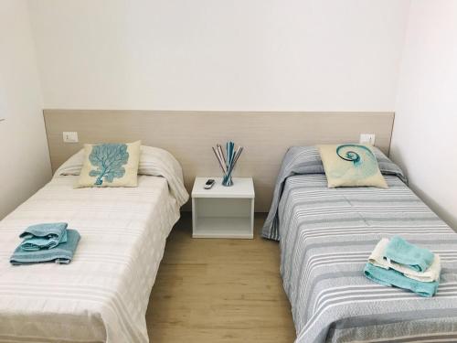 two beds sitting next to each other in a room at Sea House Tonnara in Sciacca