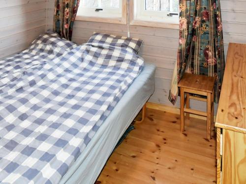 a bed in a small room with a window at 5 person holiday home in GURSKØY in Kjellsund