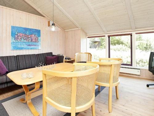 a living room with a table and chairs at 8 person holiday home in Oksb l in Vejers Strand