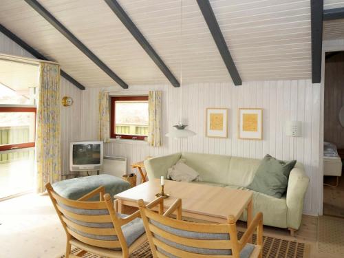 a living room with a couch and a table at 6 person holiday home in Vejers Strand in Vejers Strand