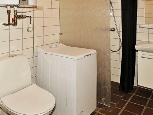 a small bathroom with a toilet and a sink at 6 person holiday home in Henne-By Traum in Henne Strand