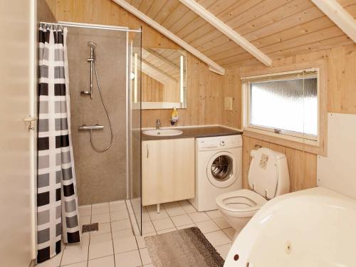 a bathroom with a shower toilet and a sink at 6 person holiday home in Hemmet in Falen