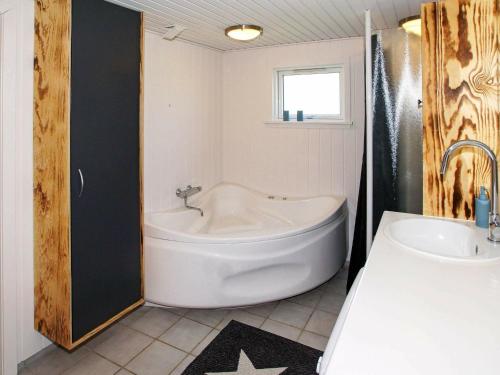 a bathroom with a tub and a toilet and a sink at 6 person holiday home in Hemmet in Hemmet