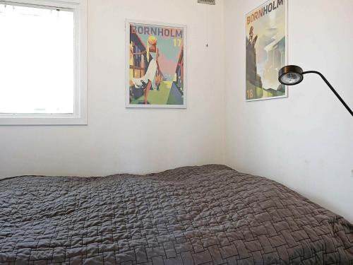 a bedroom with a bed and two posters on the wall at 6 person holiday home in Hasle-By Traum in Hasle
