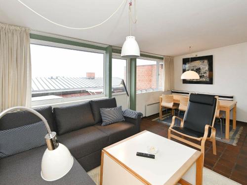 a living room with a couch and a table at 6 person holiday home in Henne-By Traum in Henne Strand