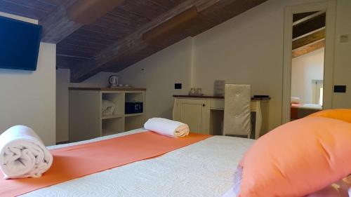 a bedroom with a bed with two towels on it at Duomo Attic (rooms) in Ravello